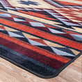 Load image into Gallery viewer, Close-up of the Ashspire Ridge rug corner showing clean edging and sharp tribal diamond pattern in rust, navy, and gold tones