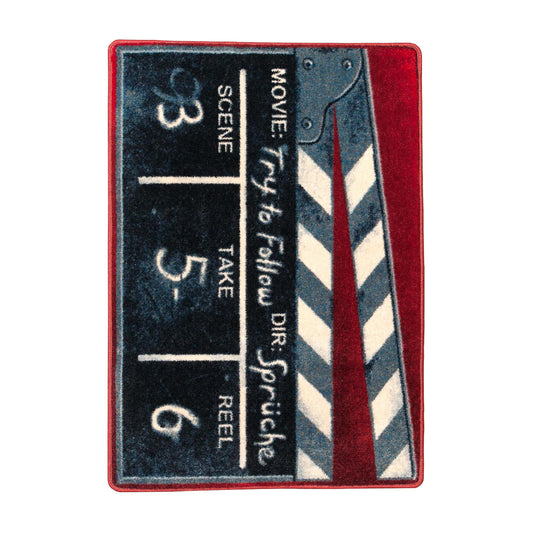 The Cue, Action Rug shown flat on a white background, featuring a classic clapperboard design in red, black, and white