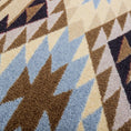Load image into Gallery viewer, Extreme close-up of The Desert’s Oracle rug yarn texture, highlighting the soft, dense weave and subtle color blending of sand, sky blue, and earth brown