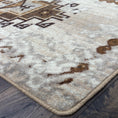Load image into Gallery viewer, Corner detail of The Driftmarch Rug showing tribal patterning and finished edge on a desert-toned background