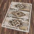 Load image into Gallery viewer, The Driftmarch Rug displayed flat on a bare floor, highlighting its full tribal pattern and warm desert-inspired color palette in tan, cream, and smoke