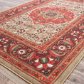Load image into Gallery viewer, The Flamekeeper’s Medallion rug displayed on a wooden floor, showcasing warm red, gold, and green vintage tones