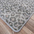 Load image into Gallery viewer, Detailed edge view of the Ghost Lynx Hide Rug, highlighting its durable binding and intricate animal-print design for immersive game room setups.