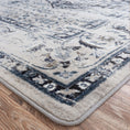 Load image into Gallery viewer, Corner of The Mistrender’s Medallion rug showing faded vine border and antique wash in blue-gray and ivory