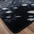 Load image into Gallery viewer, Detailed shot of the Nocturna’s Hide rug corner, showing clean edging and the organic spotted pattern along the border