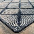 Load image into Gallery viewer, Close-up of the Prismspire rug corner showing the precise navy diamond grid pattern and neatly finished edge
