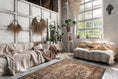 Load image into Gallery viewer, The Ravencourt Rug in a creatively styled bohemian room bursting with color, plants, vintage pieces, and curated chaos.