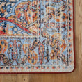 Load image into Gallery viewer, Corner of The Redreach Rug showing a crimson medallion and floral detailing bordered by parchment and deep navy accents