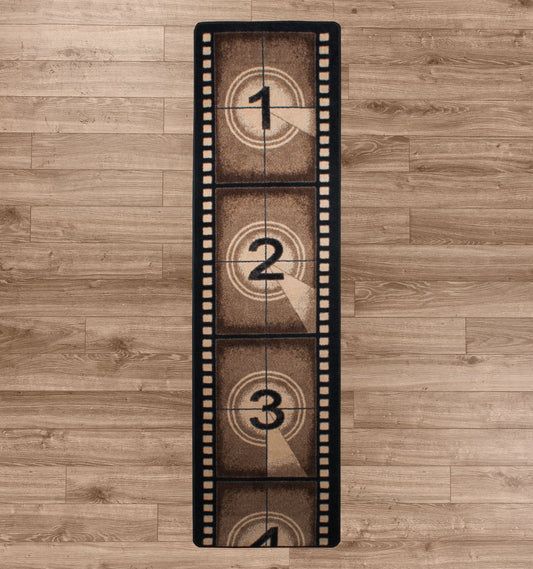 Reel Time rug laid flat on a wood floor, designed like a vintage filmstrip countdown in sepia tones
