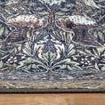 Load image into Gallery viewer, Edge of The Secret Garden rug showcasing its strong stitching and bordered woodland motif