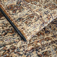 Load image into Gallery viewer, Close-up of a patterned rug with a black object on top