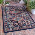 Load image into Gallery viewer, The Alchemist Rug styled in a sunlit portico, its arcane patterns glowing in ember red and turquoise
