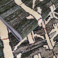 Load image into Gallery viewer, Detail shot of the Arcade Hunter rug folded over, showcasing its quality material and intricate arrowhead-inspired design.
