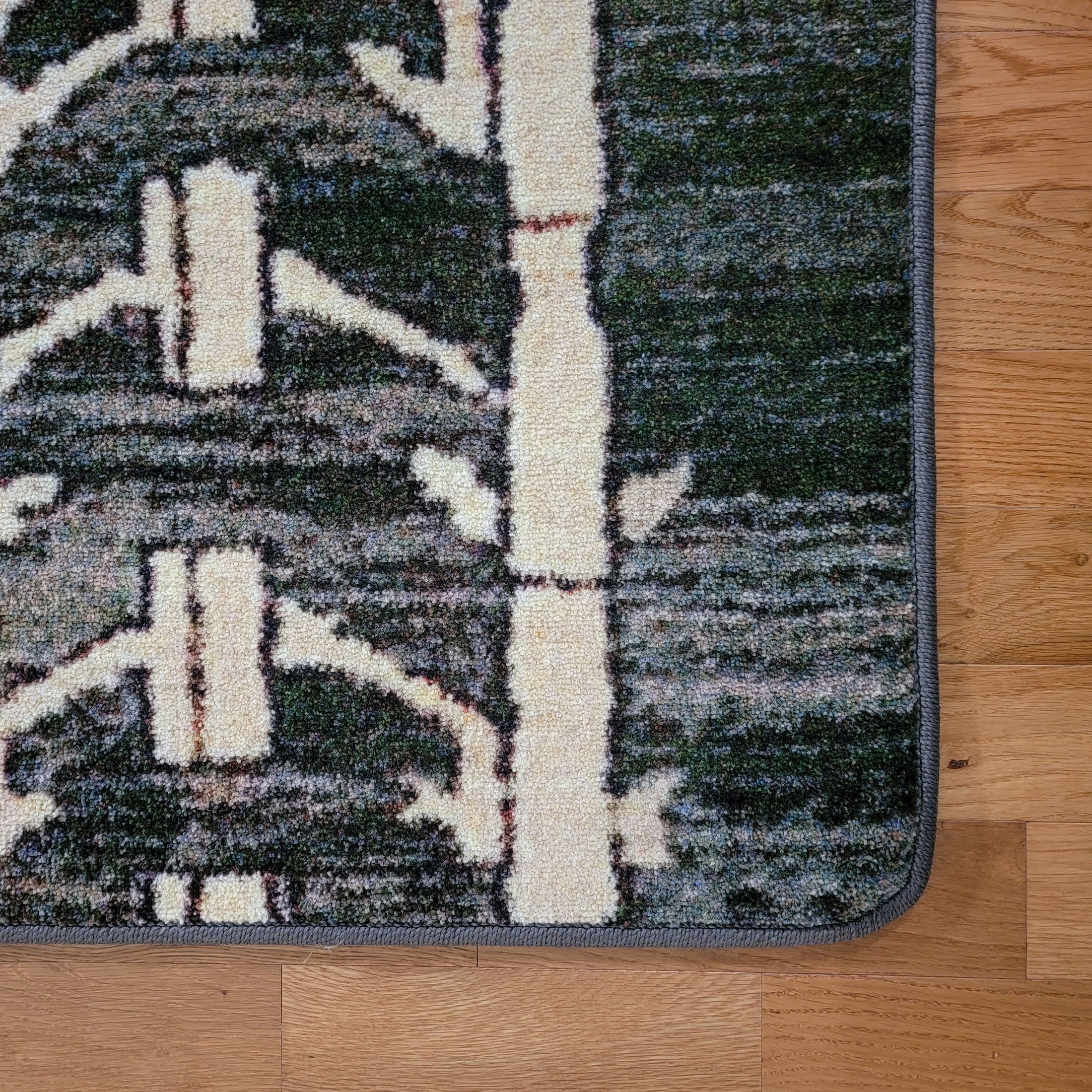 Close-up of Arcade Hunter rug’s rounded corner, showing its clean and durable finish, perfect for modern spaces.