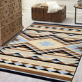 Load image into Gallery viewer, Room scene with The Desert’s Oracle rug placed beneath a vintage trunk and dresser, showcasing the sun-faded tribal diamond pattern in sand and sky blue tones

