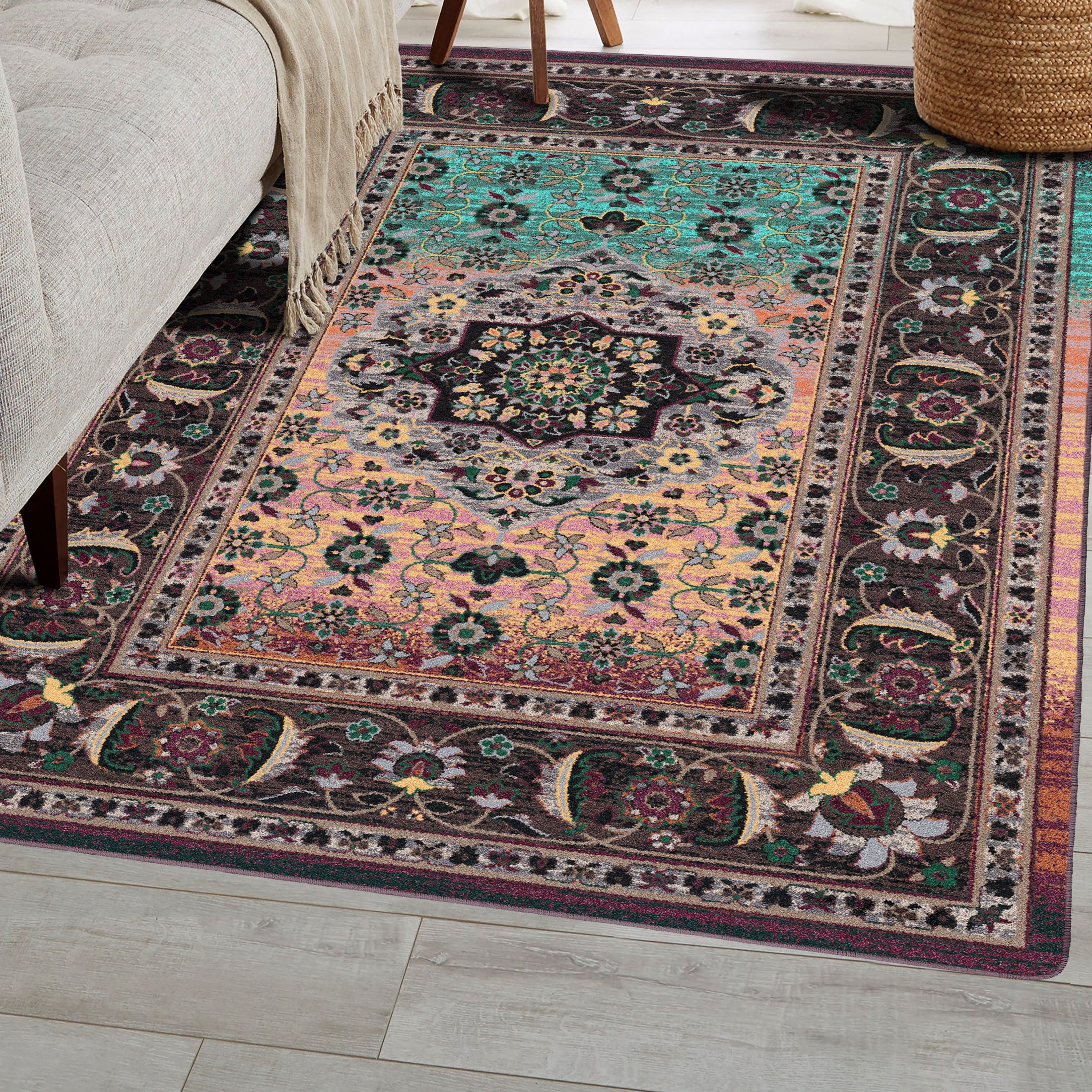 The Dreamcrafter’s Medallion rug placed in a cozy reading nook, highlighting its vibrant ombré fade and intricate medallion details in plum, amber, and jade tones


