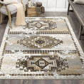 Load image into Gallery viewer, The Driftmarch Rug styled in a warm-toned room with rustic wood floors and tribal frontier energy

