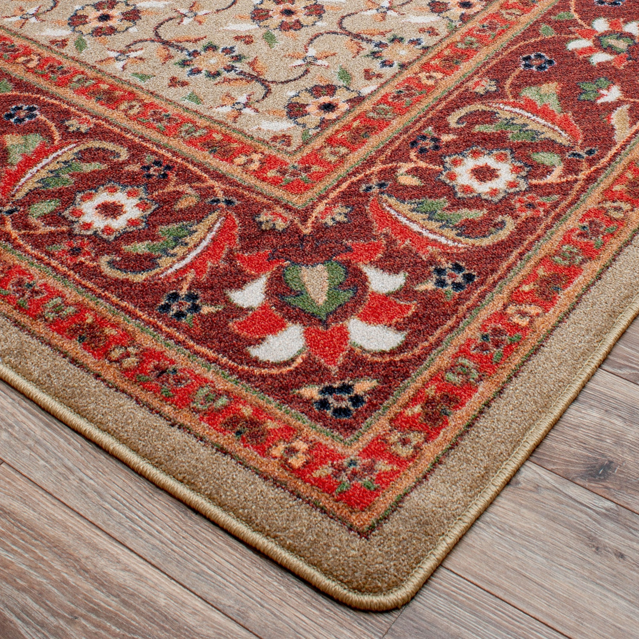 Close-up of The Flamekeeper’s Medallion rug corner showing fine floral border and rich red background