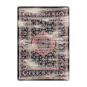  5x8 area rug featuring a soft pink medallion on a black, distressed field with floral scrollwork—The Floromancer’s Medallion evokes magic and bloom