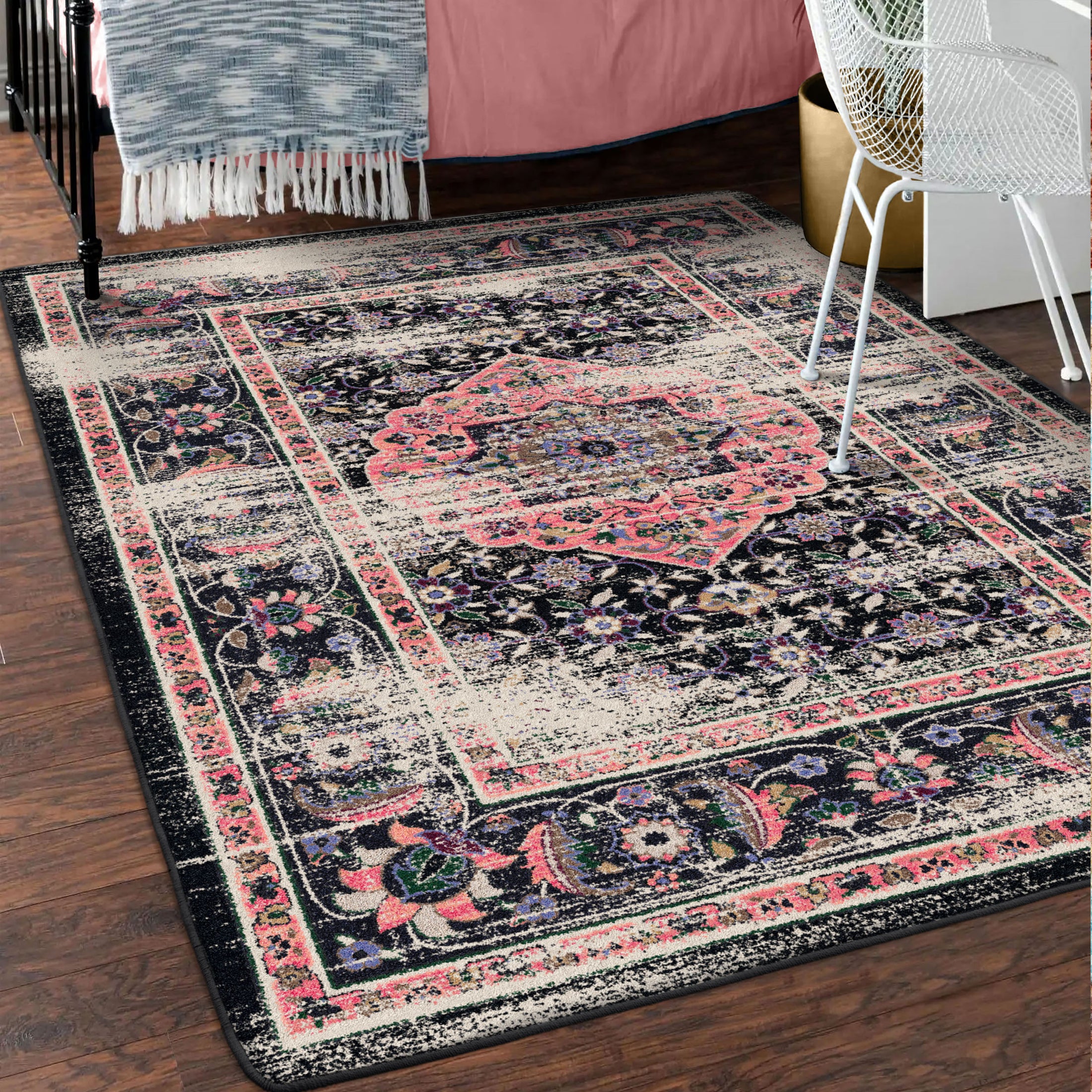 The Floromancer’s Medallion rug in a moody, elegant room with black and blush tones enhancing the floral medallion design