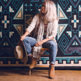 Load image into Gallery viewer, The Four Tides Rug in a model shoot, featuring intricate ocean-inspired patterns and deep blue tones, bringing an elegant and serene touch to any space.
