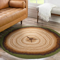 Load image into Gallery viewer, Living room scene featuring The Heartwood Stump rug beside a neutral-toned couch and bench, showing its round tree-ring design and forest green border in a cozy, nature-inspired space


