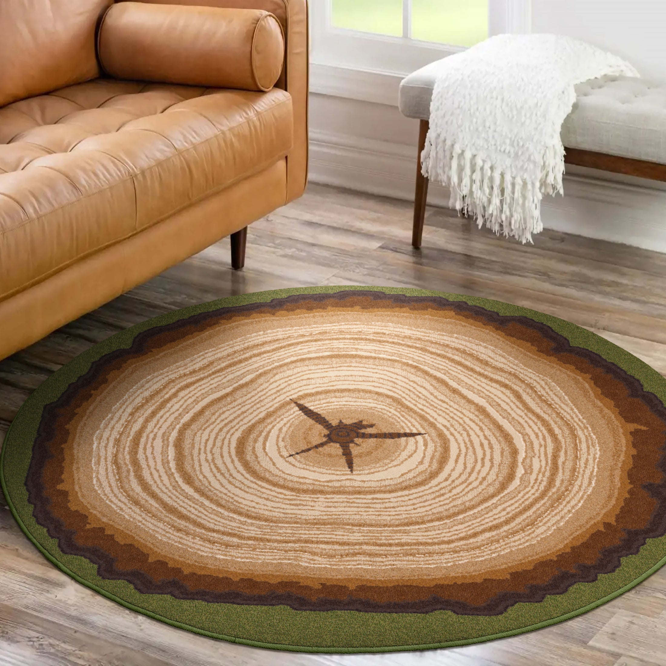 Living room scene featuring The Heartwood Stump rug beside a neutral-toned couch and bench, showing its round tree-ring design and forest green border in a cozy, nature-inspired space

