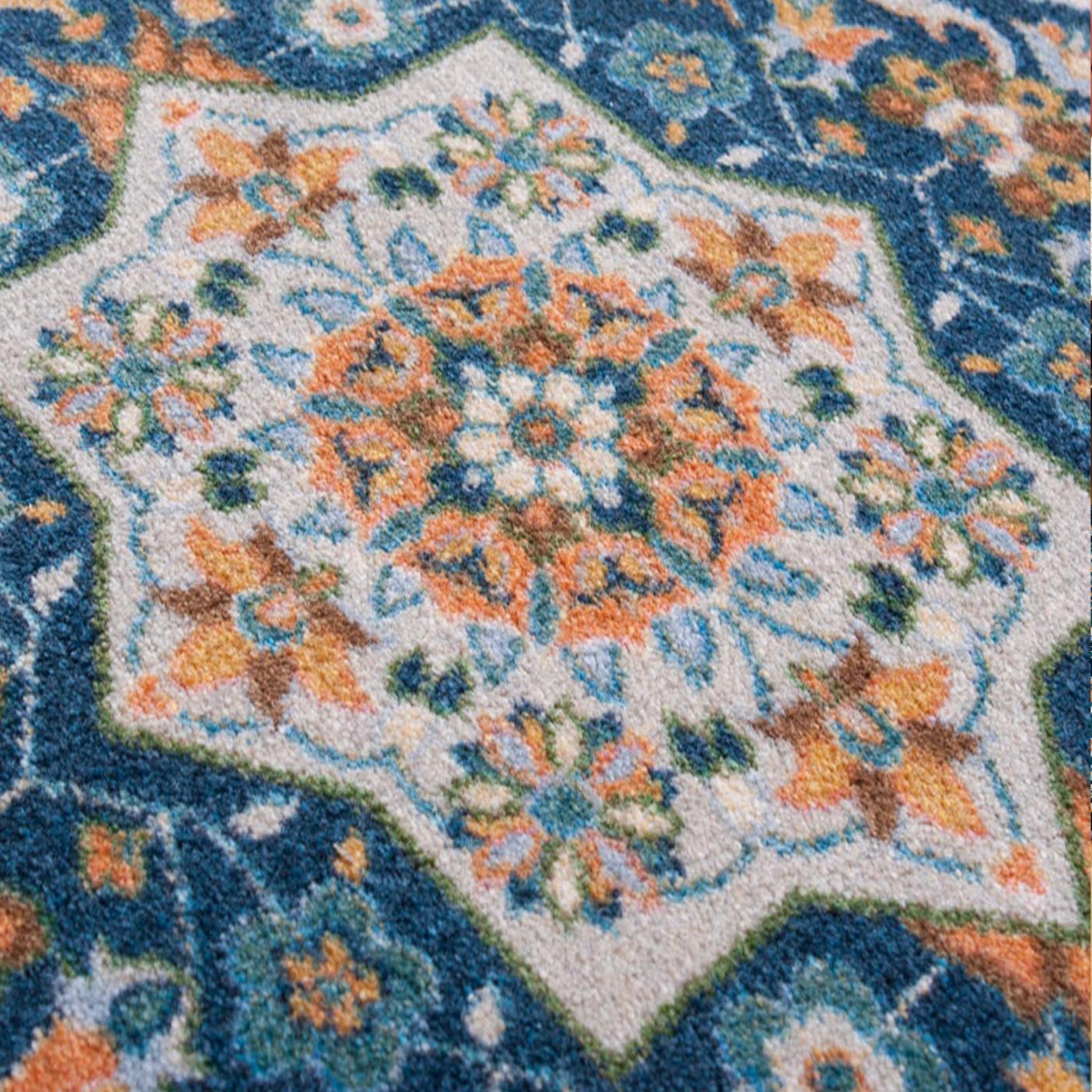 Extreme close-up of The Navigator’s Medallion rug yarn, highlighting the fine weave and color variation in parchment, teal, and gold threads

