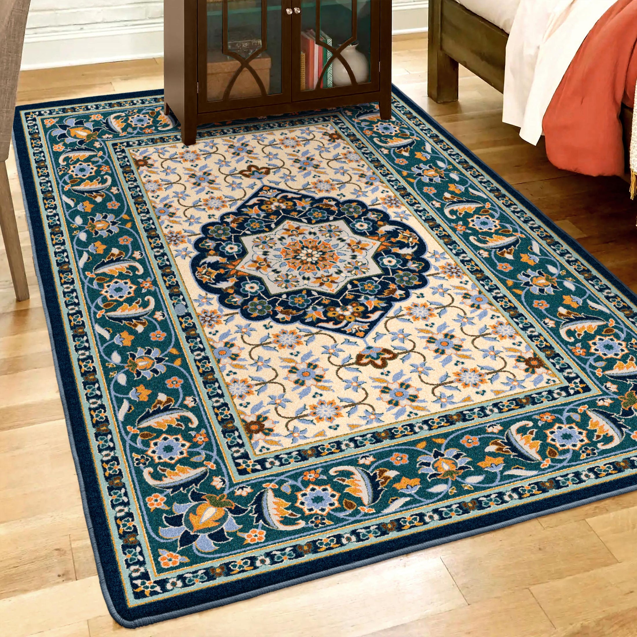 Room scene featuring The Navigator’s Medallion rug beneath furniture, highlighting its parchment-toned field, teal scrollwork, and classic medallion design in a nautical-inspired space


