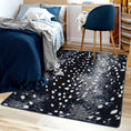 Load image into Gallery viewer, Bedroom scene featuring Nocturna’s Hide rug beneath a bed, highlighting its dark, moon-dappled pattern in a cozy, softly lit space


