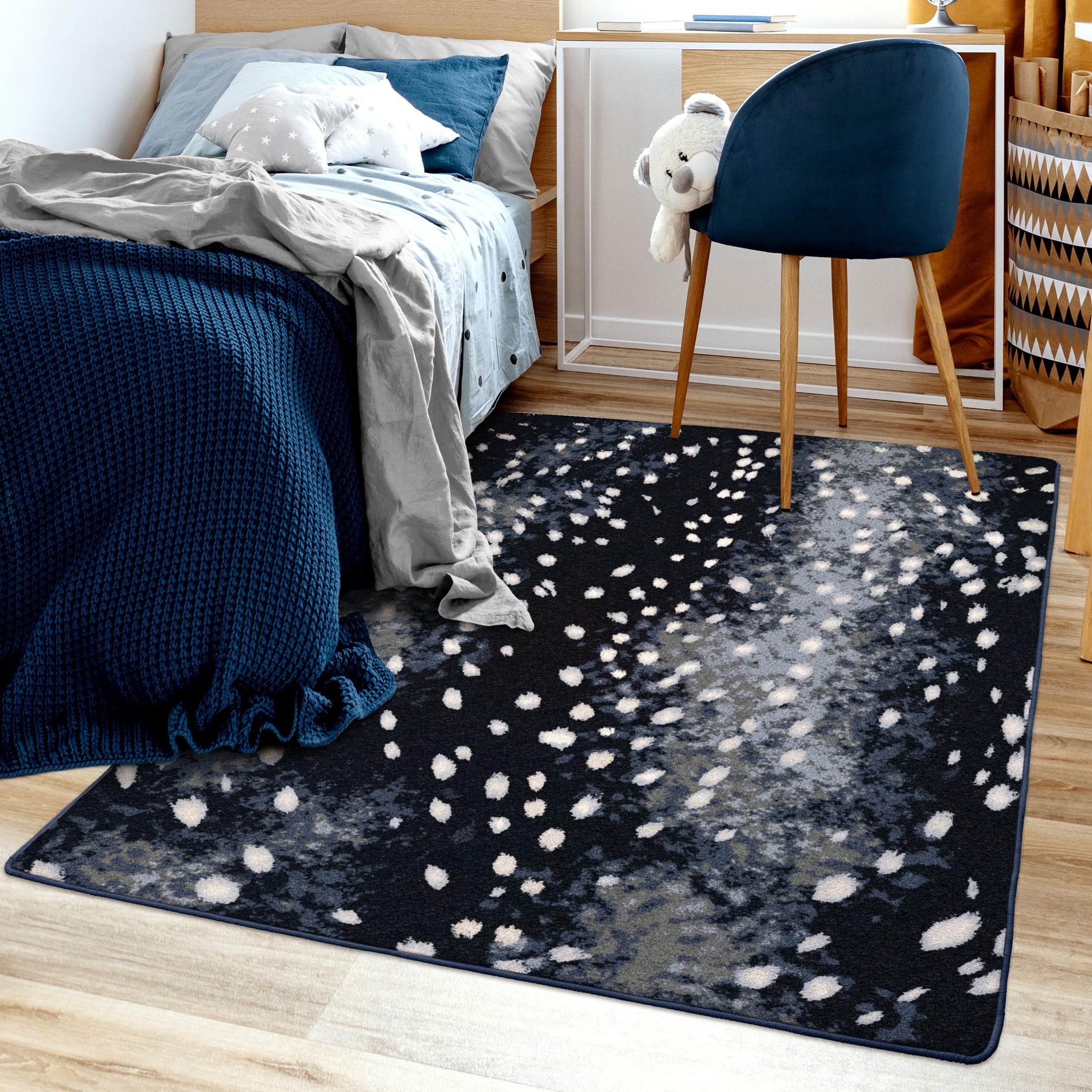 Bedroom scene featuring Nocturna’s Hide rug beneath a bed, highlighting its dark, moon-dappled pattern in a cozy, softly lit space

