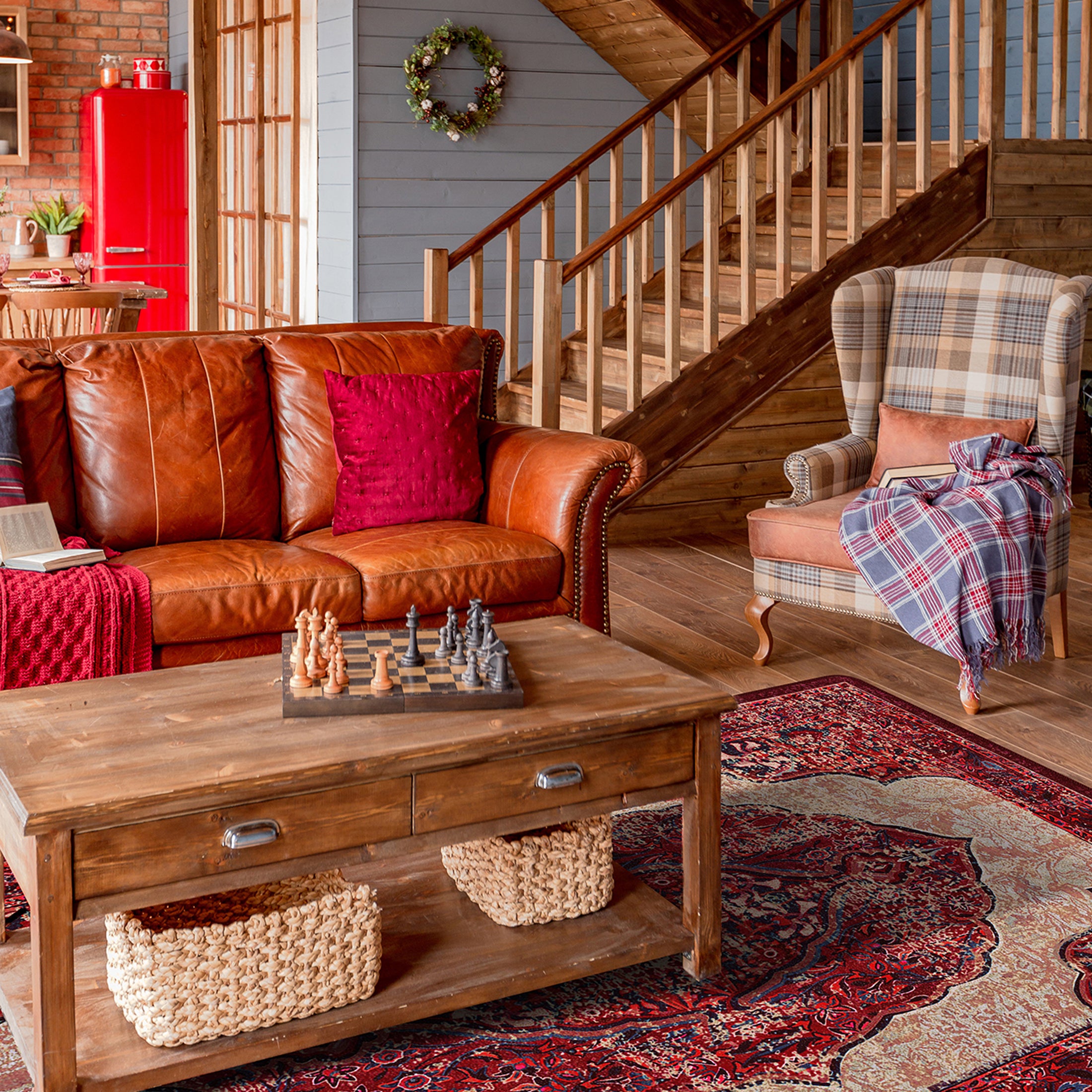 The Oathforged Rug styled in a cozy living room with warm wood tones and soft lighting, highlighting its rich shield design