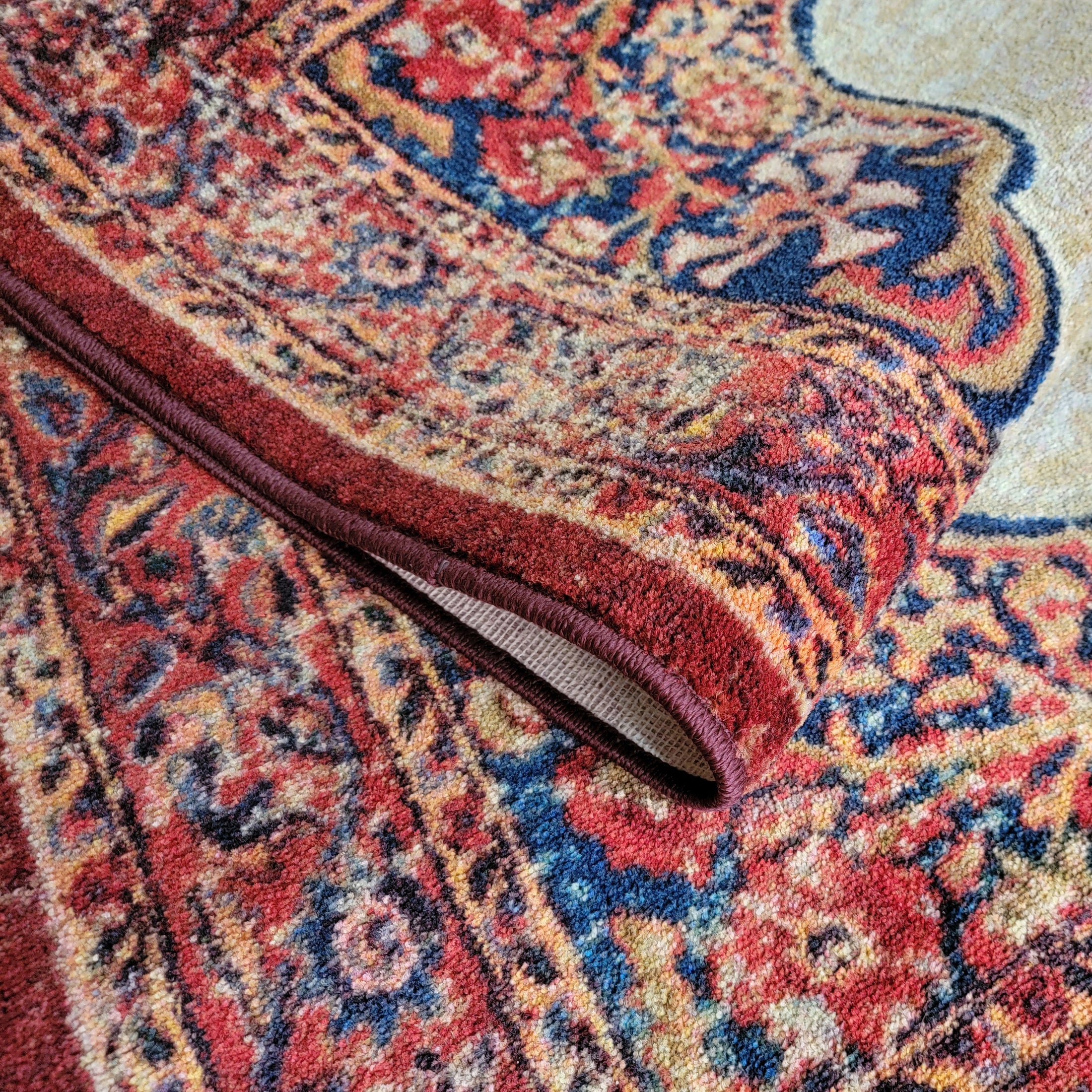 The Oathforged Rug partially folded to showcase its layered weave, soft texture, and ceremonial color palette