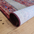 Load image into Gallery viewer, The Oathforged Rug rolled up to show the textured nylon weave and sturdy commercial-grade backing
