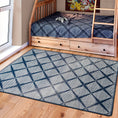 Load image into Gallery viewer, Room scene featuring the Prismspire rug placed beneath boys’ bunk beds, with a navy and cream diamond grid design for a modern, clean look
