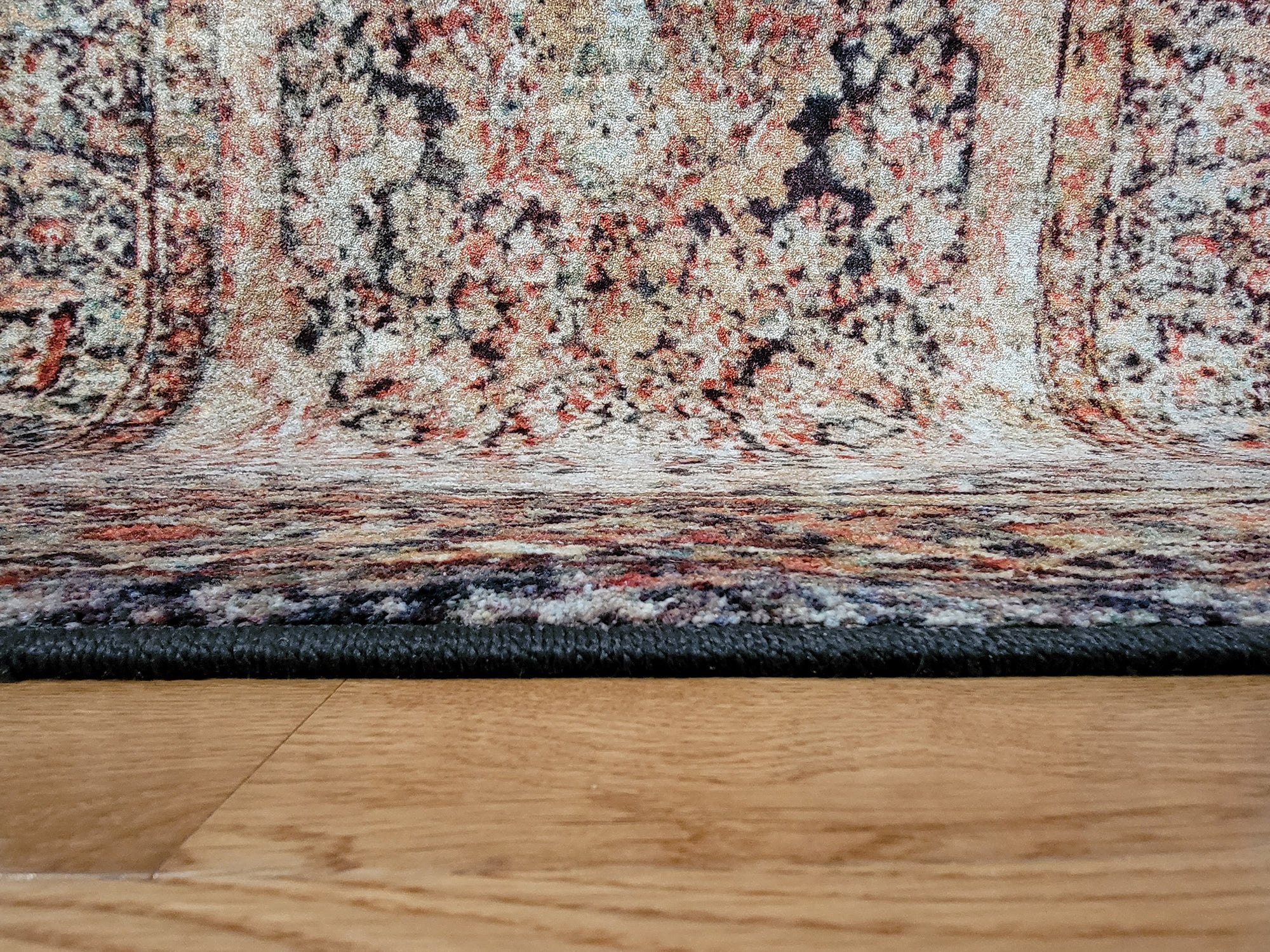 Close-up of The Ravencourt Rug edge showing tight surge, strong backing, and clean lines of its gothic floral design.

