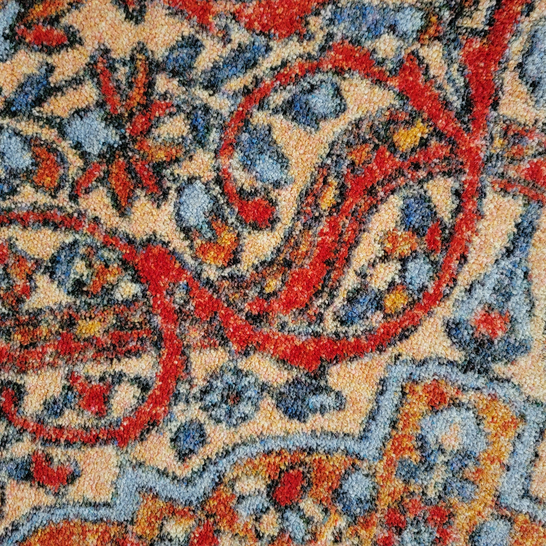 Close-up view of The Redreach Rug’s textured surface and intricate EnduraStran yarn weave in red, gold, and cream