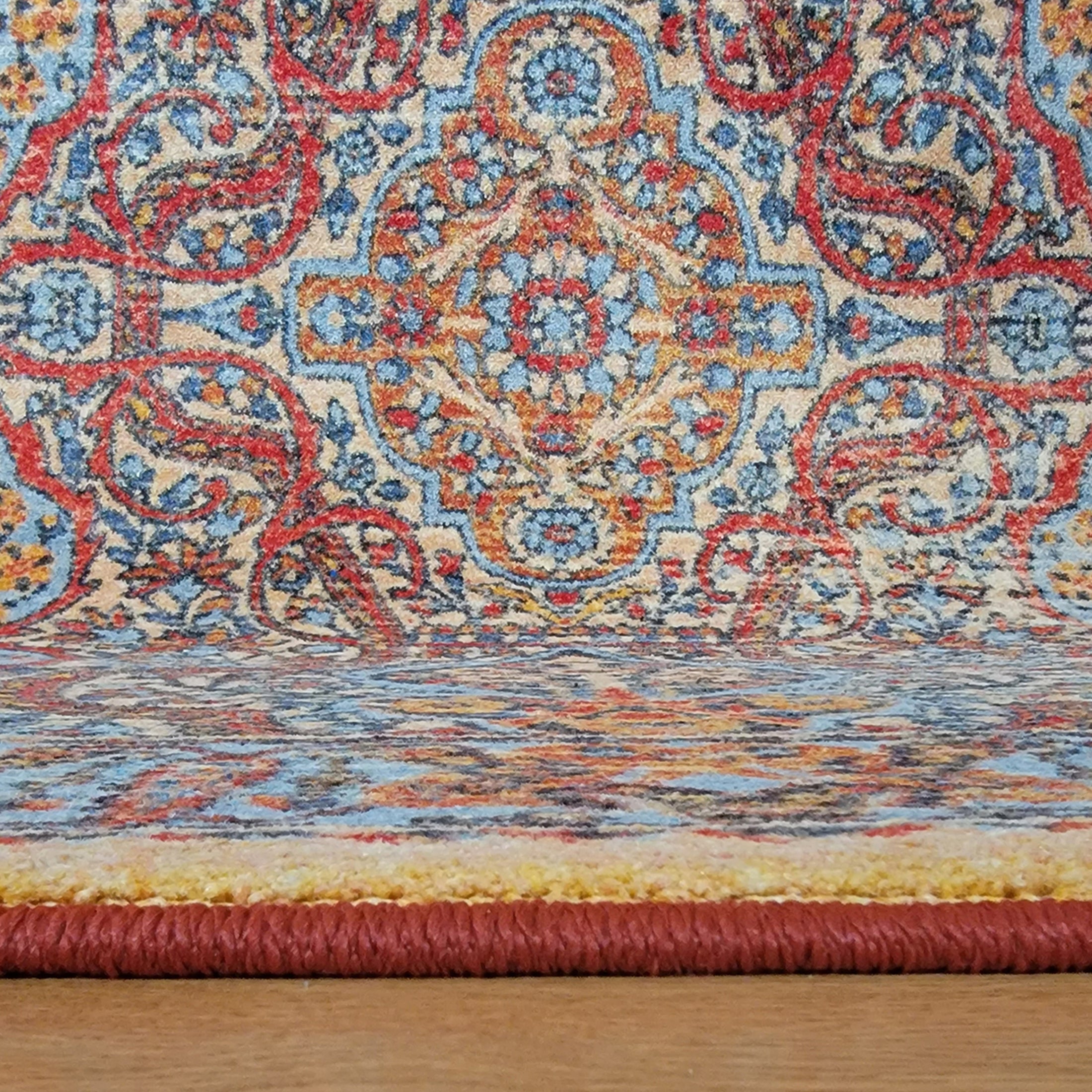Close-up of The Redreach Rug’s edge showing its reinforced surge stitching and deep red border tones

