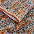 Load image into Gallery viewer, The Redreach Rug folded to reveal its layered texture and richly woven crimson, gold, and parchment pattern


