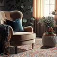 Load image into Gallery viewer, The Redreach Rug styled in a warm-toned room with rustic décor, showing its red and gold medallion pattern
