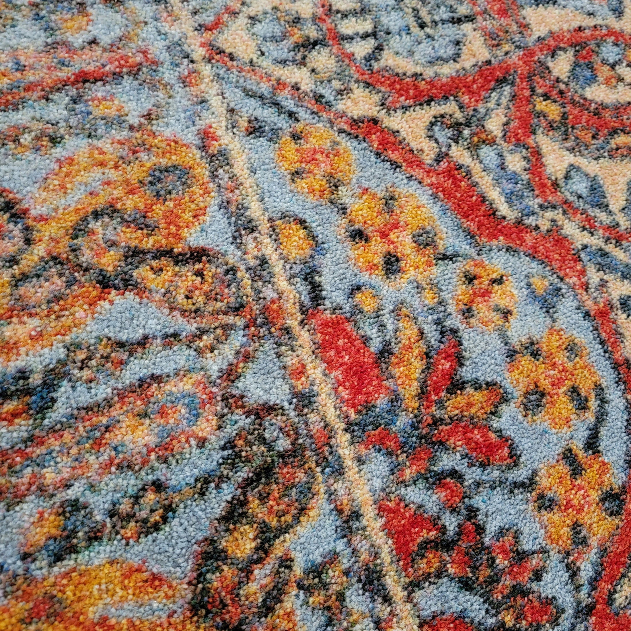 Extreme close-up of The Redreach Rug showing fine yarn threads and detailed fiber texture in vibrant red and ivory tones