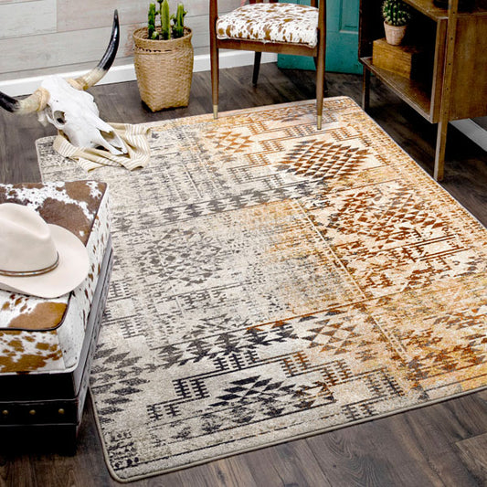 Southwestern-style room featuring the Sandveil Map rug with cowhide furniture, cactus accents, and rustic decor.