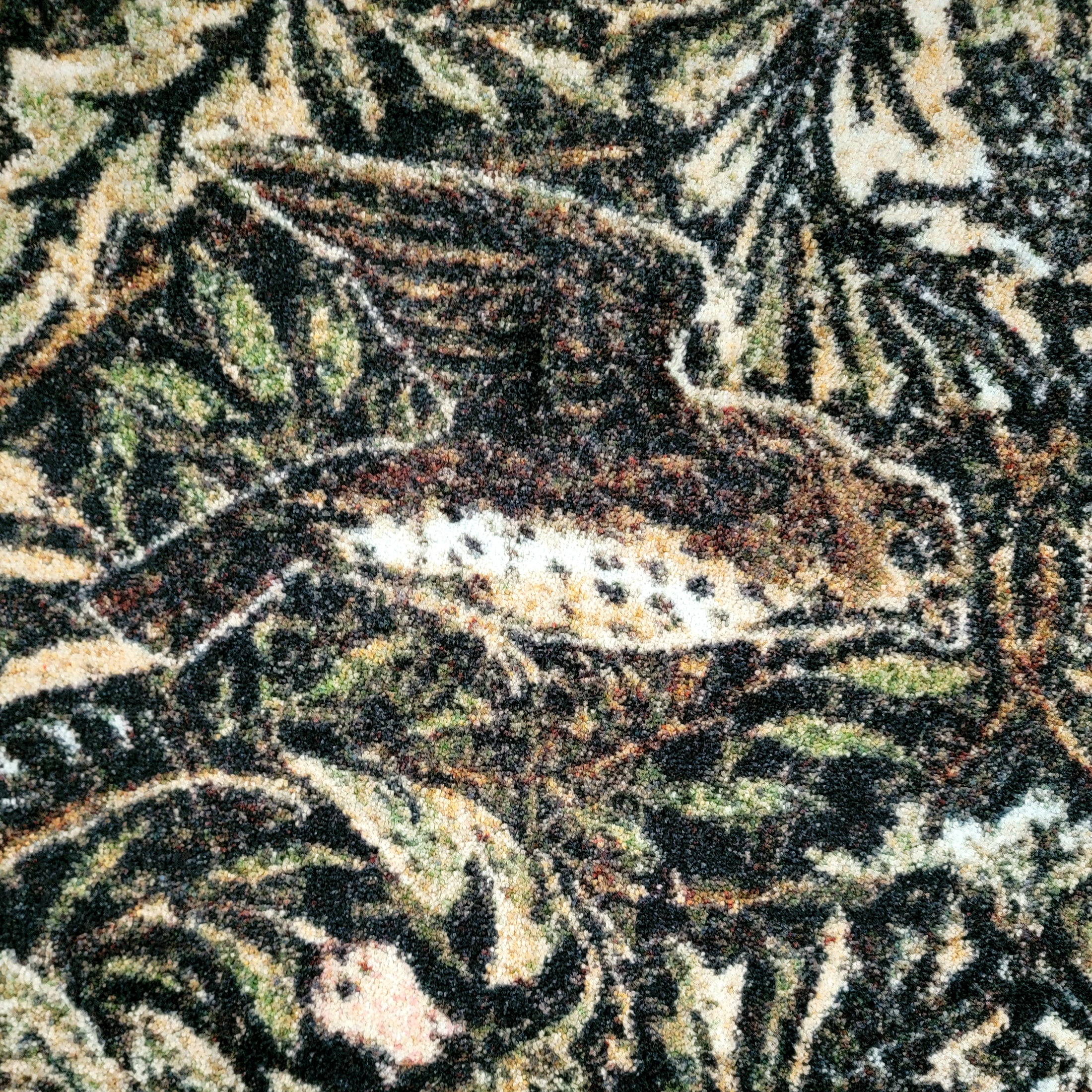 Texture of The Secret Garden rug in moss, rose, and bark tones with visible yarn and nature-inspired designs