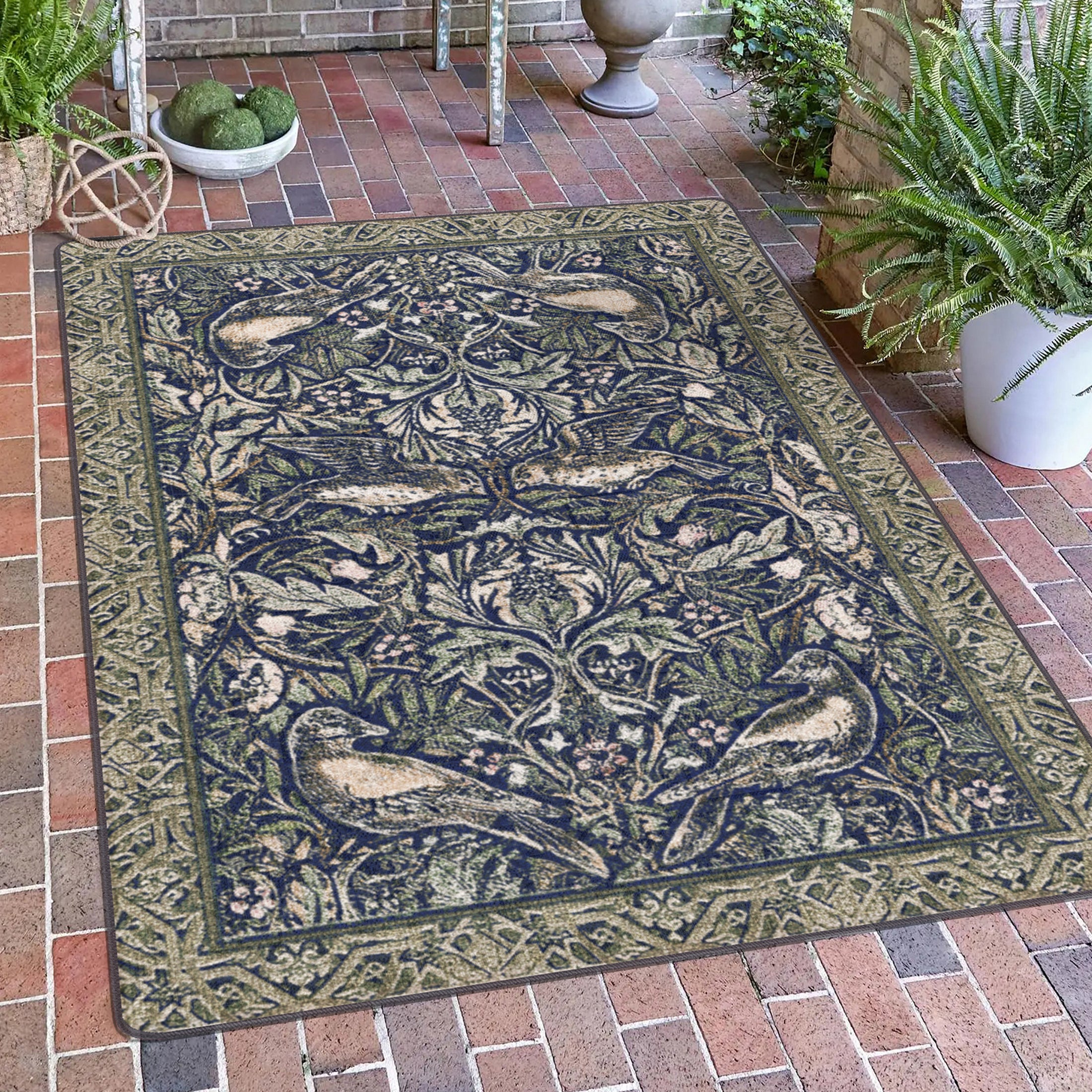 The Secret Garden rug displayed on a covered portico with leafy details and a symmetrical forest pattern of birds and vines