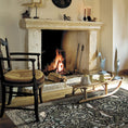 Load image into Gallery viewer, The Secret Garden rug styled in a vintage living room with mossy green tones, intricate floral and bird design, and an ornate forest-inspired layout
