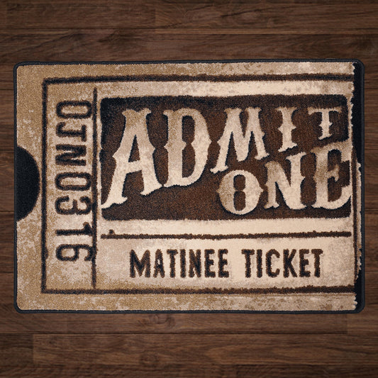 Silver Screen rug in a styled room with wood flooring, featuring a nostalgic matinee ticket design in cream and sepia shades