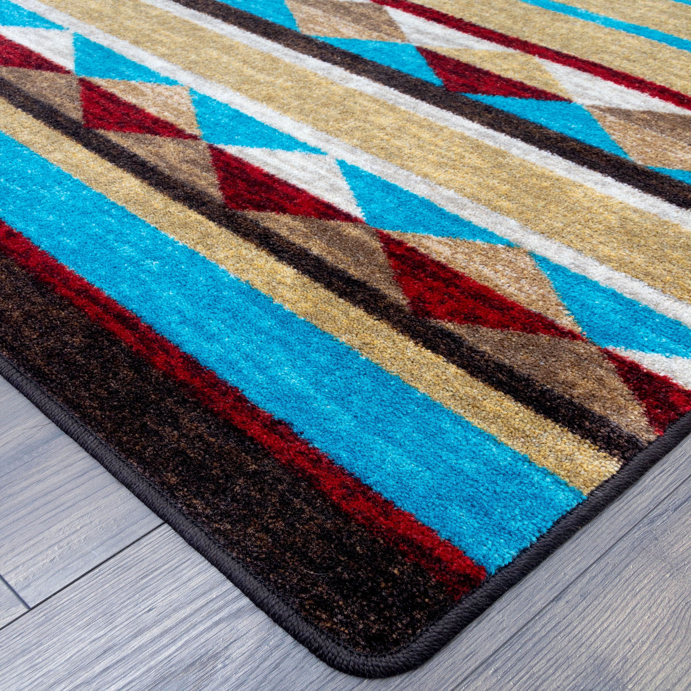 Close-up of the Trail of Glass rug corner, showing detailed tribal pattern and clean edging in turquoise, rust, and sandy gold