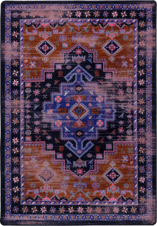 Decorative rug with intricate patterns in blue, orange, and purple on a dark background
