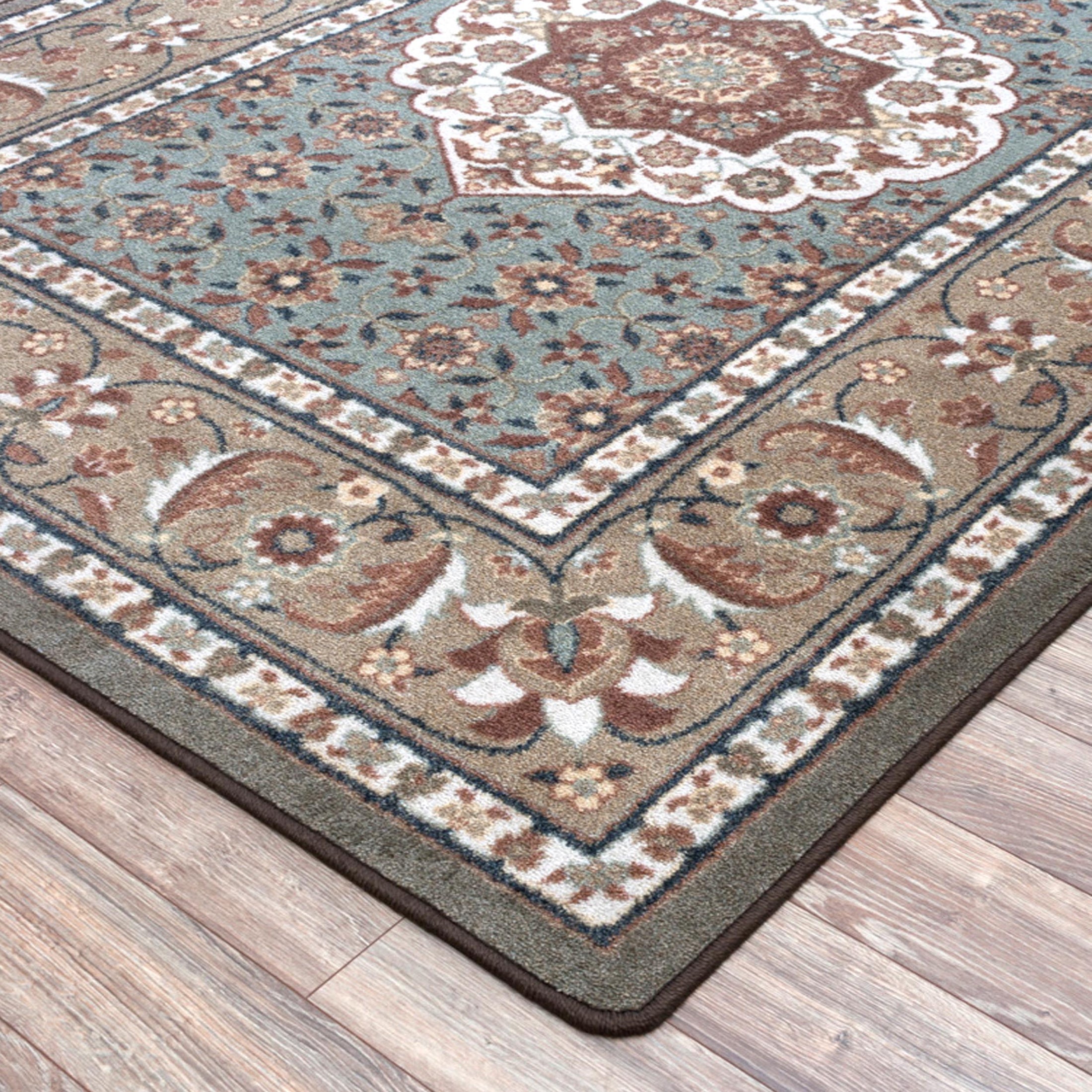 Corner close-up of The Weaver’s Medallion rug showing its intricate border pattern and soft earth-toned weave


