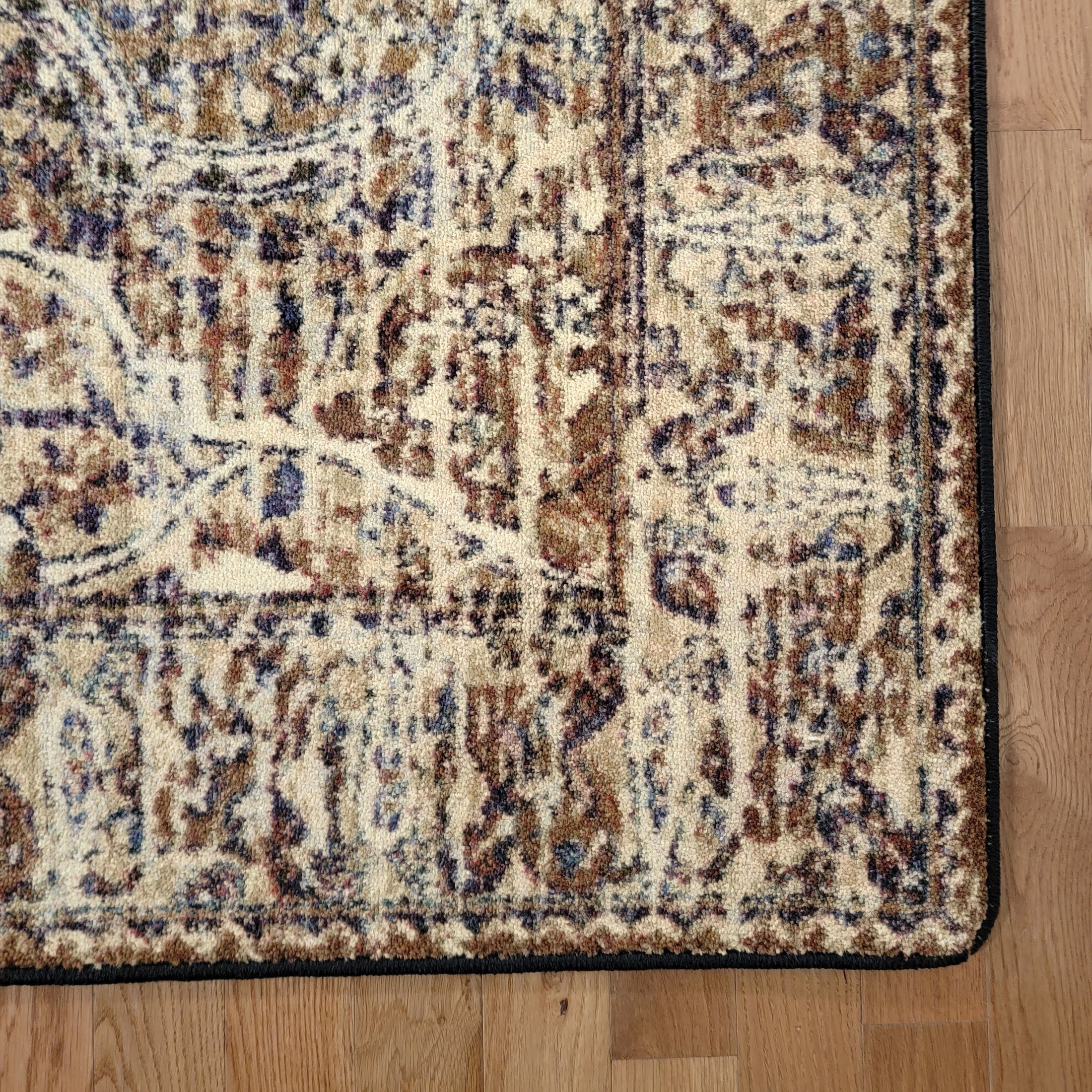 Close-up of a patterned rug on a wooden floor